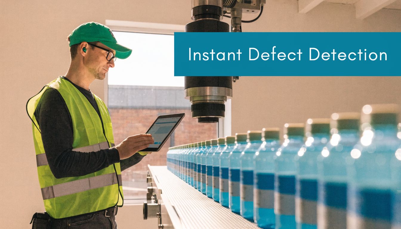 A factory worker in a safety vest using a tablet to inspect blue beverage bottles on a conveyor.